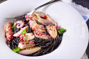 octopus with black spaghetti and garlic sauce
