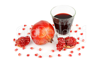 Pomegranate juice in a glass and ripe pomegranates. Isolated on