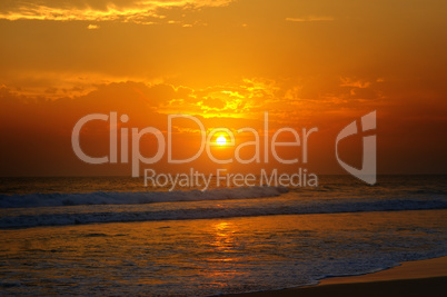 Beach of the ocean and golden sun rise.