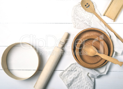 wooden round plates, sieve and rolling pin