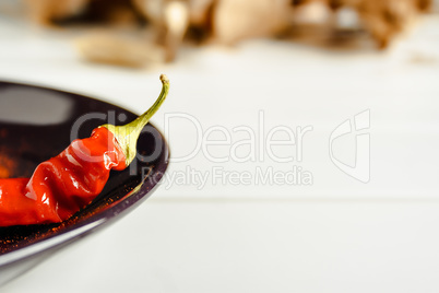 Red pepper on brown dish.