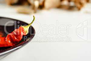 Red pepper on brown dish.