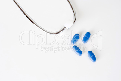 Blue pills with stethoscope