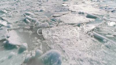 Aerial view of ice on the sea with sunlight. Pack contains 4 clip