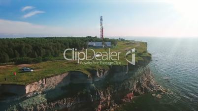 Aerial flying along the coast with a view of the coastline with cliffs from the sea and on land The Old Lighthouse