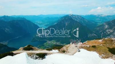 Aerial panoramic view of view of observation deck on the snowy mountains and flying paraglider in Austria. Beautiful views in Alps
