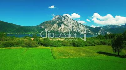 Aerial panoramic view of mountain next the lake with yachts
