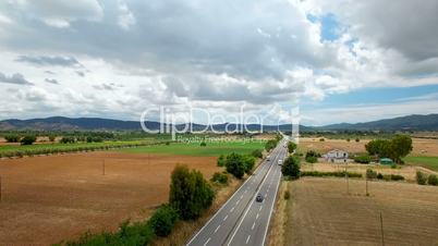 Aerial view of driving cargo by highway in the rural countryside . Aerial view on the mountains in Tuscany, Italy