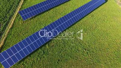 Aerial flight over the solar panel on the field in sunny day in Italy, Tuscany