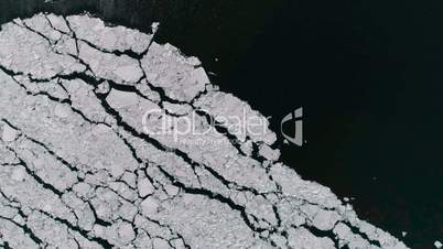 Aerial view of ice on the sea with sunlight. Pack contains 3 clip