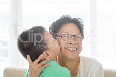 Grandchild kissing grandmother