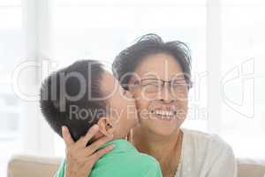 Grandchild kissing grandmother