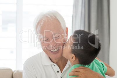 Grandchild kissing grandfather