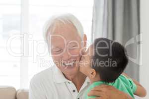 Grandchild kissing grandfather