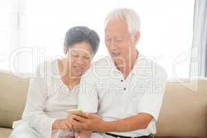 Old couple using smart phones