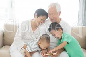 Grandparents and grandchildren using smart phones