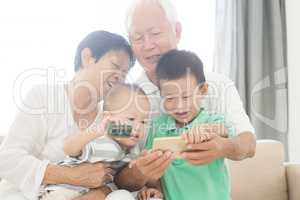 Grandparents and grandchildren selfie with smart phones