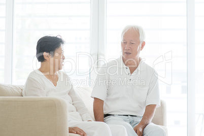 Old couple chatting at home