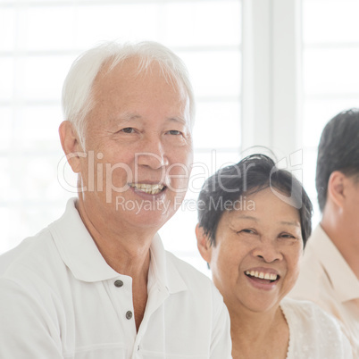 Old couple at home, smiling happy