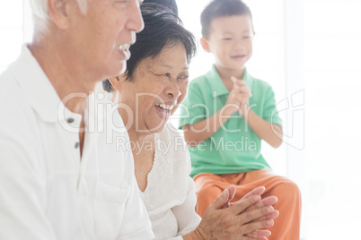 Happy Asian family clapping hands