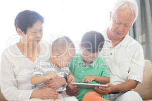 Grandparents and grandchildren using tablet pc
