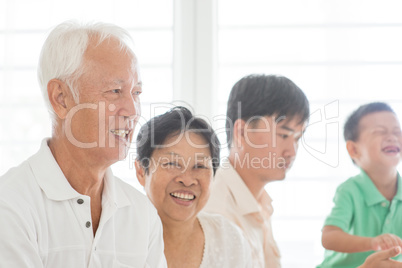 Happy Asian family indoors