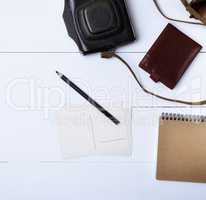 empty paper postcards and a black wooden pencil on a white woode