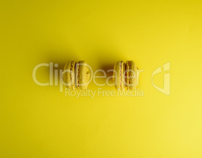 two yellow macarons on a yellow background