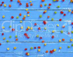 abstract blue background of the wooden planks and colorful candy