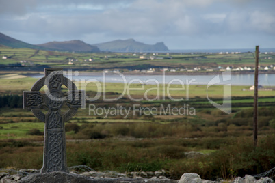 Celtic cross with irish landscape