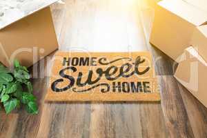Home Sweet Home Welcome Mat, Moving Boxes and Plant on Hard Wood