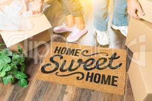 Man and Woman Unpacking Near Home Sweet Home Welcome Mat, Moving