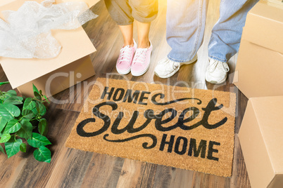 Man and Woman Standing Near Home Sweet Home Welcome Mat, Moving