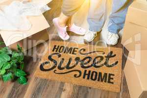 Man and Woman Standing Near Home Sweet Home Welcome Mat, Moving