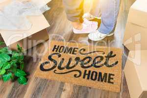 Man and Woman Standing Near Home Sweet Home Welcome Mat, Moving