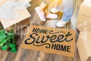 Man and Woman Standing Near Home Sweet Home Welcome Mat, Moving