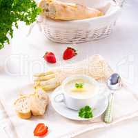 asparagus cream soup with capers and fresh baguette