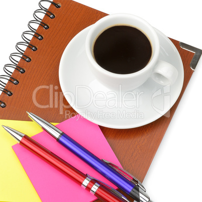 Notebook and cup of coffee isolated on white background.