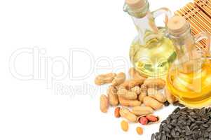 Peanuts, sunflower seeds and vegetable oils isolated on white ba