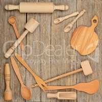 Kitchen wooden utensils (spoon, plate, fork, pestle) on a table