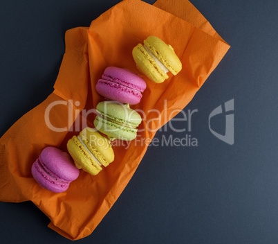 multicolored macarons on an orange napkin