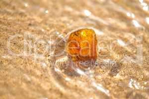 Amber on a beach of the Baltic Sea in the surf