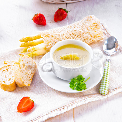 asparagus cream soup with capers and fresh baguette