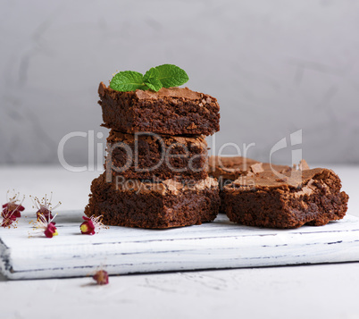 pieces of chocolate brownie on a white wooden board