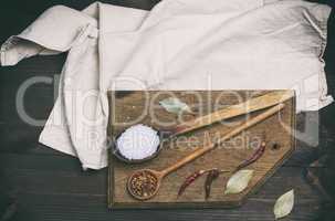 wooden spoon with white salt and spices