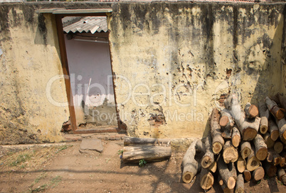 Indian village. Firewood stacked in pile in front of house