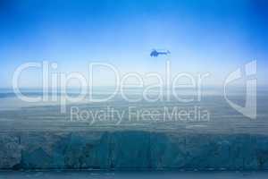 Helicopter over clouded Arctic glaciers.