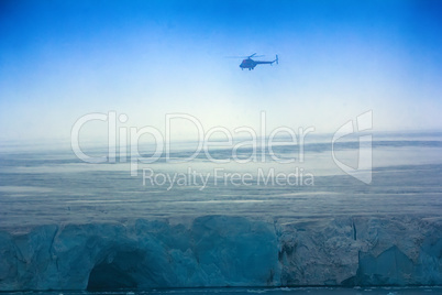 Helicopter over clouded Arctic glaciers.