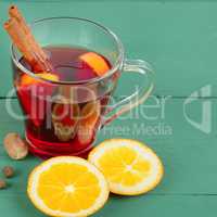 Hot red mulled wine on wooden background with spices. Free space