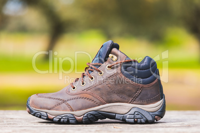 hiking boot on a wood table in the nature